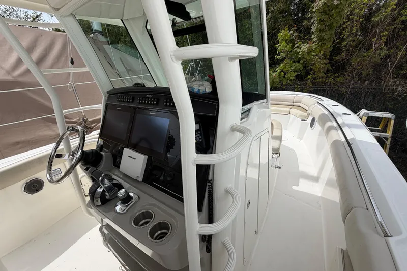 Slide: The Image of 2016 Boston Whaler 330 Outrage boat interior with helm and seating area. - 12