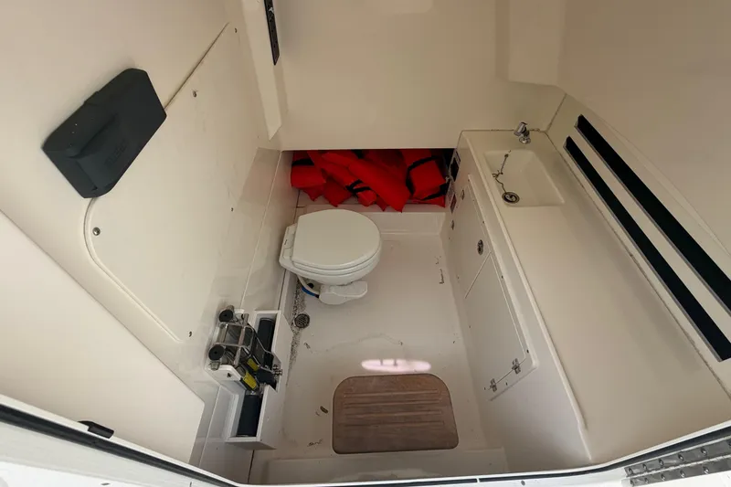 Slide: The Image of Interior of 2016 Boston Whaler 330 Outrage boat with toilet and sink. - 14
