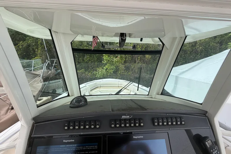 Slide: The Image of Cockpit view of 2016 Boston Whaler 330 Outrage with navigation controls and windshield. - 15