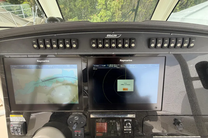 Slide: The Image of Control panel of a 2016 Boston Whaler 330 Outrage with Raymarine displays. - 18
