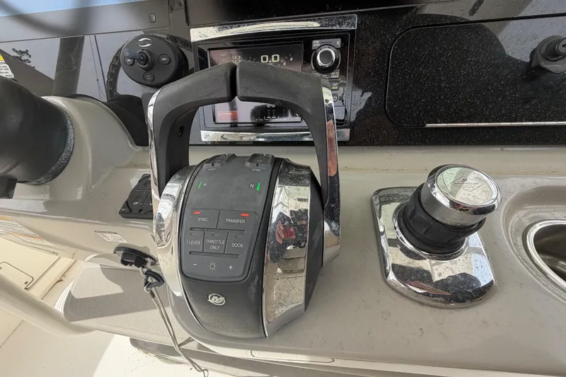 Slide: The Image of Control panel of a 2016 Boston Whaler 330 Outrage boat, featuring throttle and joystick controls. - 20