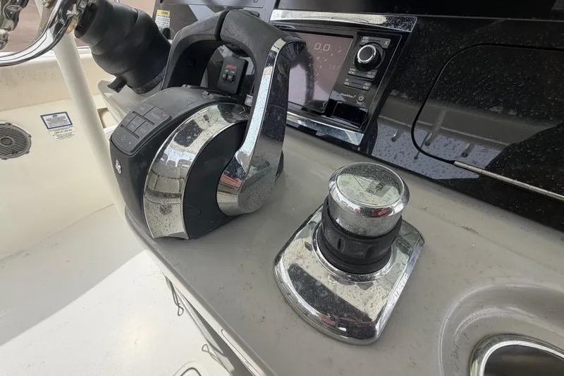 Slide: The Image of Control panel of a 2016 Boston Whaler 330 Outrage boat, featuring throttle and joystick. - 21