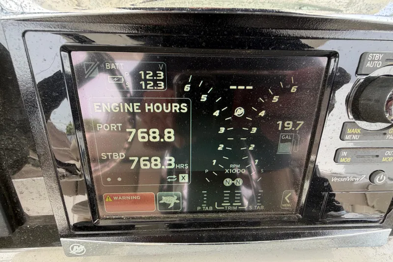 Slide: The Image of Display panel of a 2016 Boston Whaler 330 Outrage showing engine hours and battery voltage. - 23