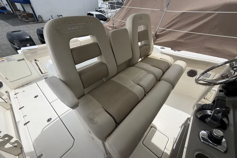 Slide: The Image of 2016 Boston Whaler 330 Outrage boat seating and helm area. - 27