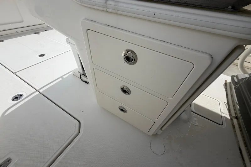 Slide: The Image of Storage drawers on a 2016 Boston Whaler 330 Outrage boat deck. - 29