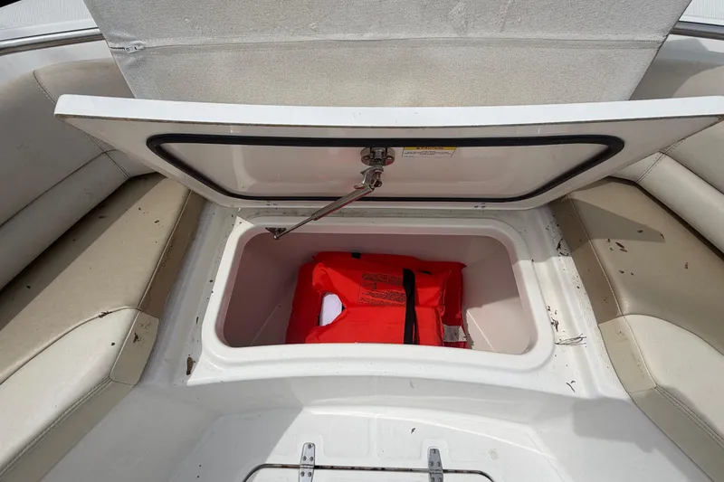 Slide: The Image of Open storage compartment on 2016 Boston Whaler 330 Outrage with life jacket inside. - 3