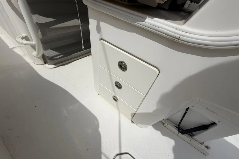 Slide: The Image of 2016 Boston Whaler 330 Outrage boat interior with storage compartments. - 30