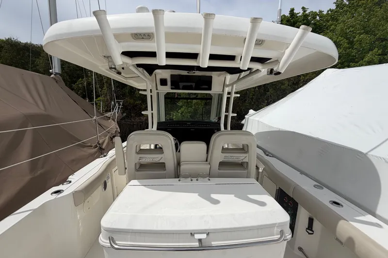 Slide: The Image of 2016 Boston Whaler 330 Outrage boat interior with seating and rod holders. - 31