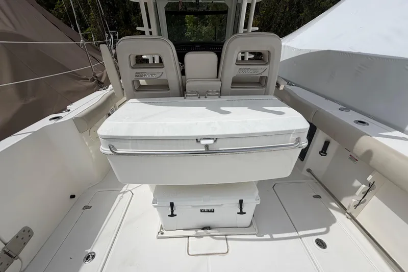 Slide: The Image of 2016 Boston Whaler 330 Outrage boat interior with seating and storage. - 32