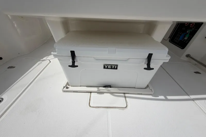 Slide: The Image of White YETI cooler on 2016 Boston Whaler 330 Outrage boat deck. - 36