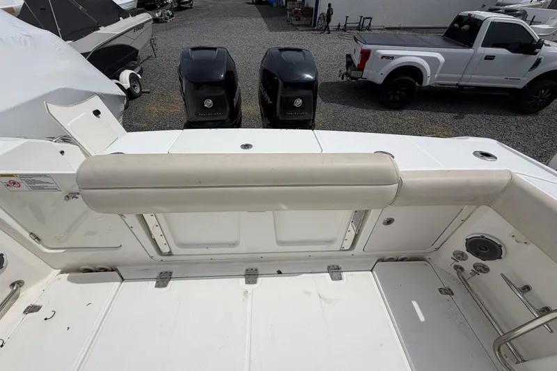 Slide: The Image of 2016 Boston Whaler 330 Outrage boat deck with twin outboard engines. - 38