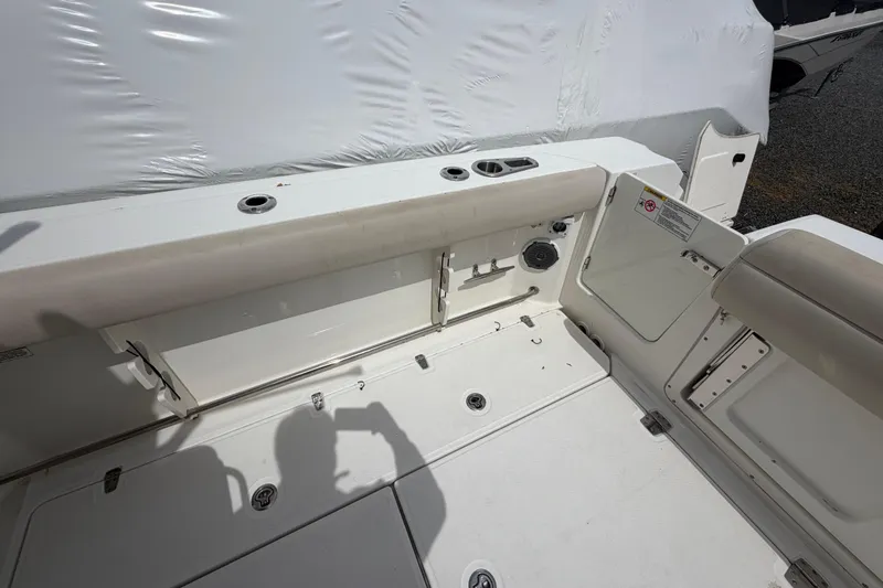 Slide: The Image of 2016 Boston Whaler 330 Outrage boat interior with seating and storage compartments. - 39