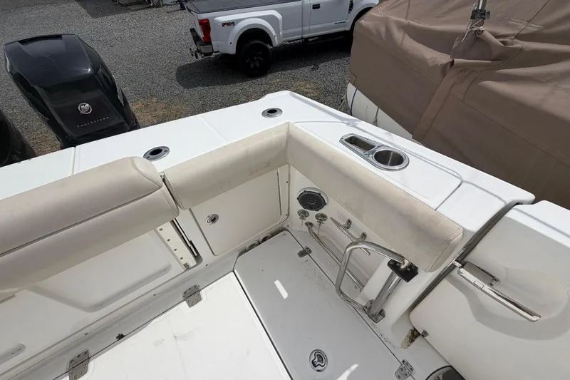 Slide: The Image of 2016 Boston Whaler 330 Outrage boat interior with seating and cup holder. - 40