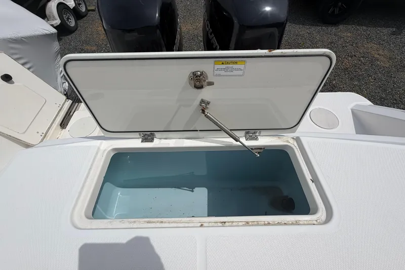 Slide: The Image of Open storage compartment on a 2016 Boston Whaler 330 Outrage boat, showcasing interior space. - 42