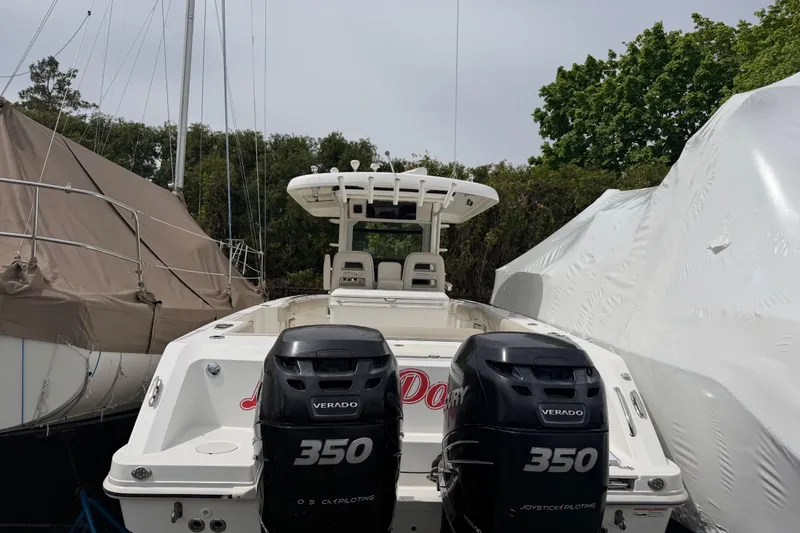 Slide: The Image of 2016 Boston Whaler 330 Outrage with twin Mercury Verado 350 engines, docked outdoors. - 48