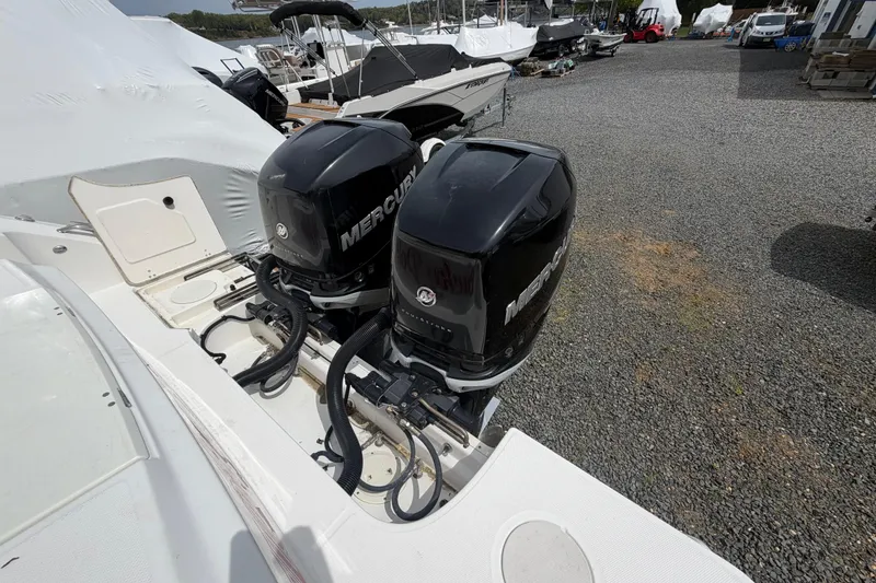 Slide: The Image of 2016 Boston Whaler 330 Outrage with dual Mercury outboard engines in a boatyard. - 49