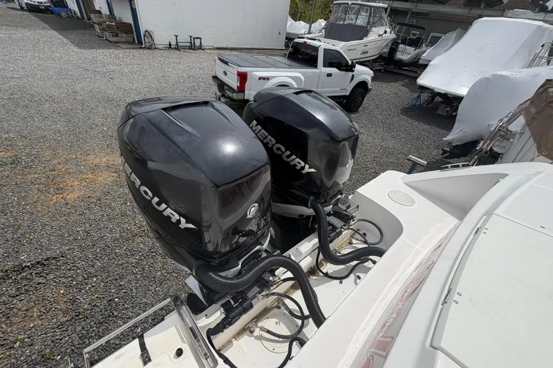 Slide: The Image of 2016 Boston Whaler 330 Outrage with twin Mercury outboard engines in a boatyard. - 50