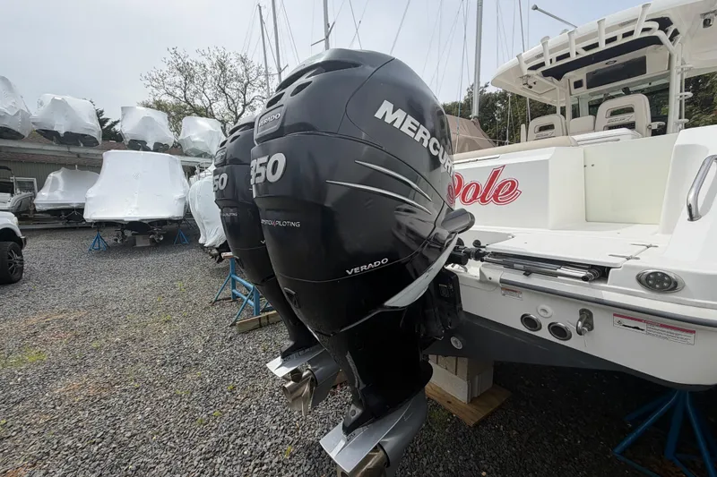 Slide: The Image of Boston Whaler 330 Outrage 2016 with twin Mercury 350 Verado engines in storage yard. - 53