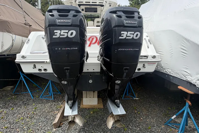 Slide: The Image of Boston Whaler 330 Outrage 2016 with twin Verado 350 engines on stands. - 54
