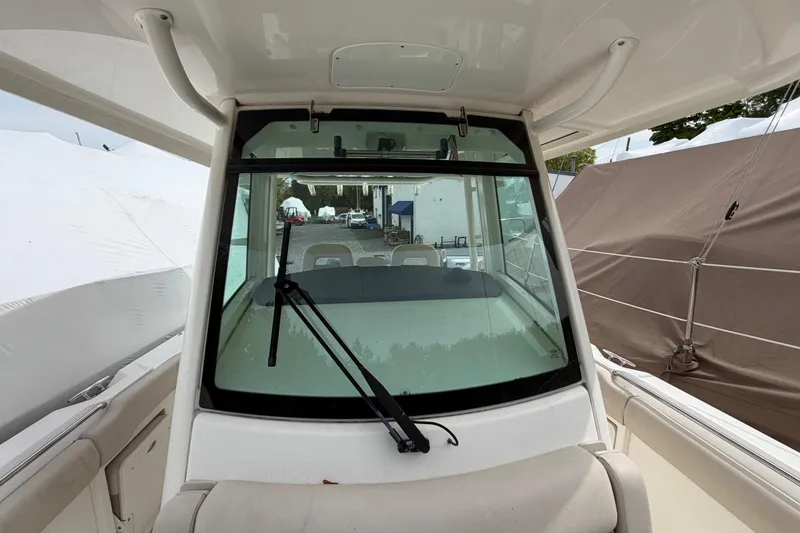 Slide: The Image of 2016 Boston Whaler 330 Outrage boat windshield and cockpit view. - 6
