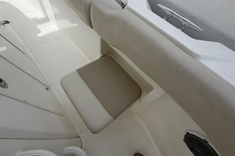 Slide: The Image of 2016 Boston Whaler 330 Outrage boat interior with beige seating and stainless steel cleat. - 7
