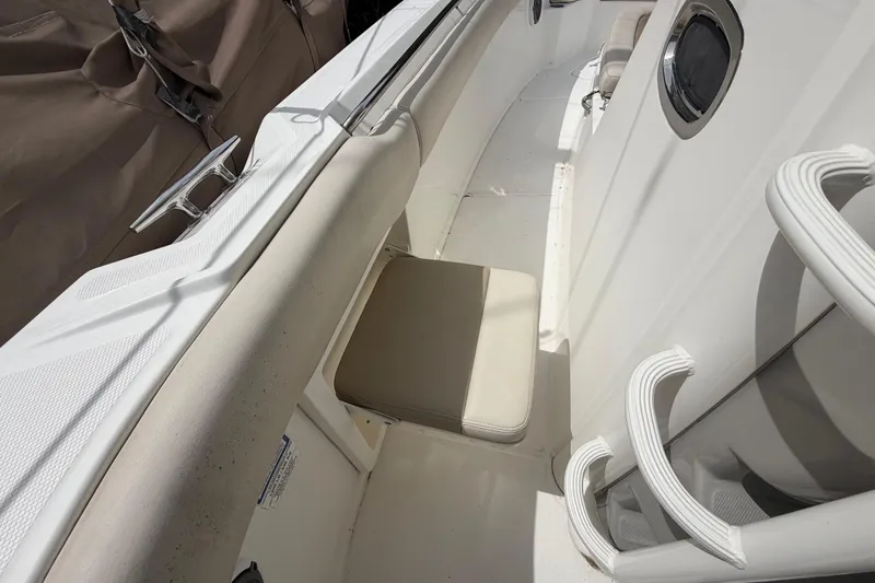 Slide: The Image of 2016 Boston Whaler 330 Outrage interior with beige seating and white deck details. - 8