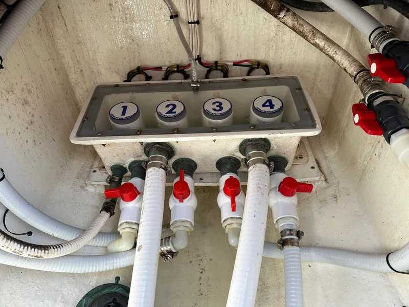 Slide: The Image of 2007 Contender 33 Tournament boat plumbing system with numbered valves and red handles. - 19