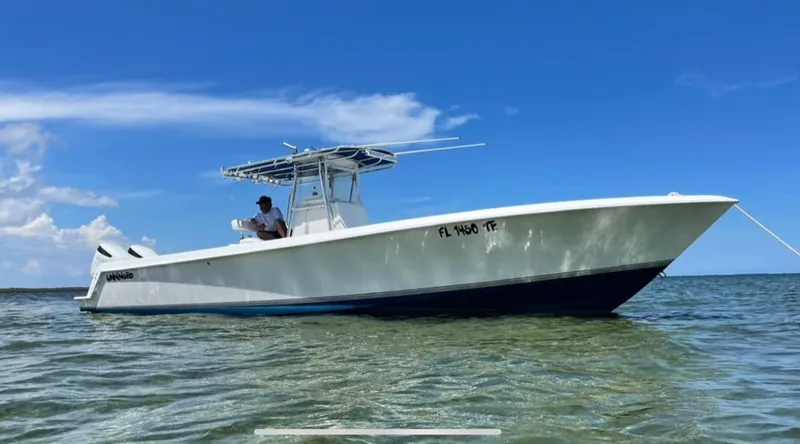 Slide: The Image of 2007 Contender 33 Tournament boat on water under clear blue sky. - 22