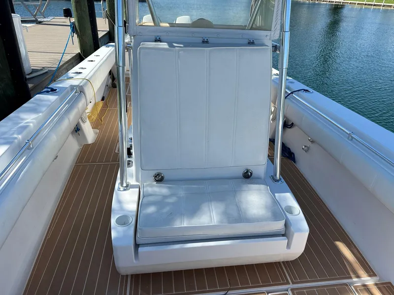 Slide: The Image of 2007 Contender 33 Tournament boat interior with white seating and wooden deck. - 6
