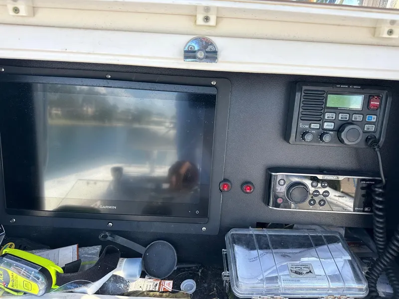Slide: The Image of 2007 Contender 33 Tournament boat dashboard with Garmin display and communication equipment. - 9