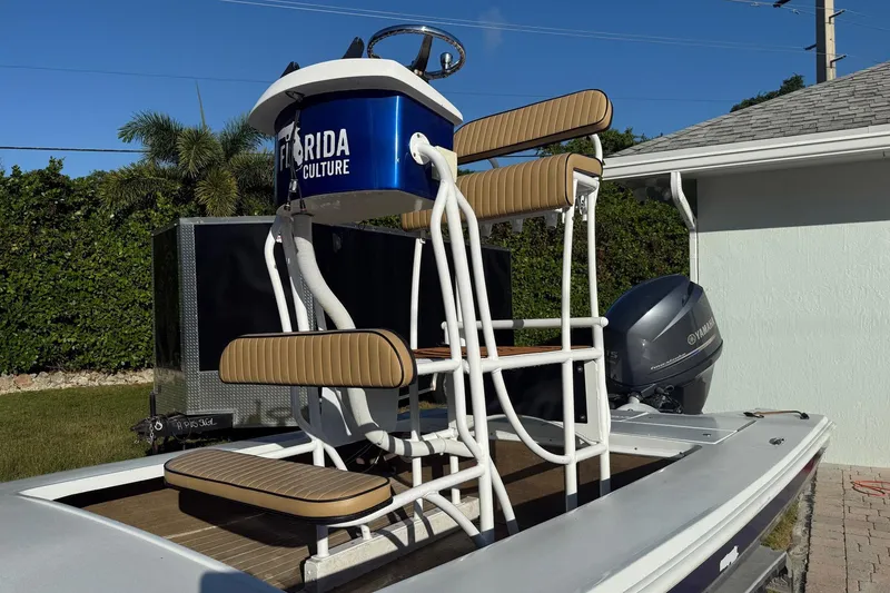 Slide: The Image of 1986 Dolphin 18 Skiff boat with elevated seating and Yamaha outboard motor. - 3