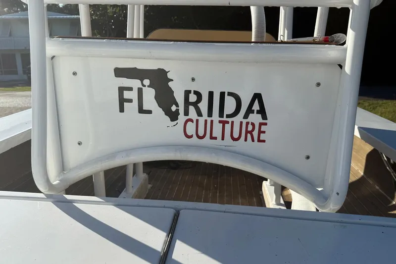 Slide: The Image of 1986 Dolphin 18 Skiff boat with "Florida Culture" logo on the back. - 5