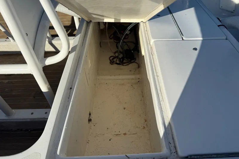 Slide: The Image of Open storage compartment on a 1986 Dolphin 18 Skiff boat, showing interior details. - 6