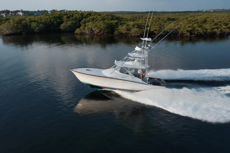 Slide: The Image of 2016 F&S Express boat cruising on calm water near lush green shoreline. - 42
