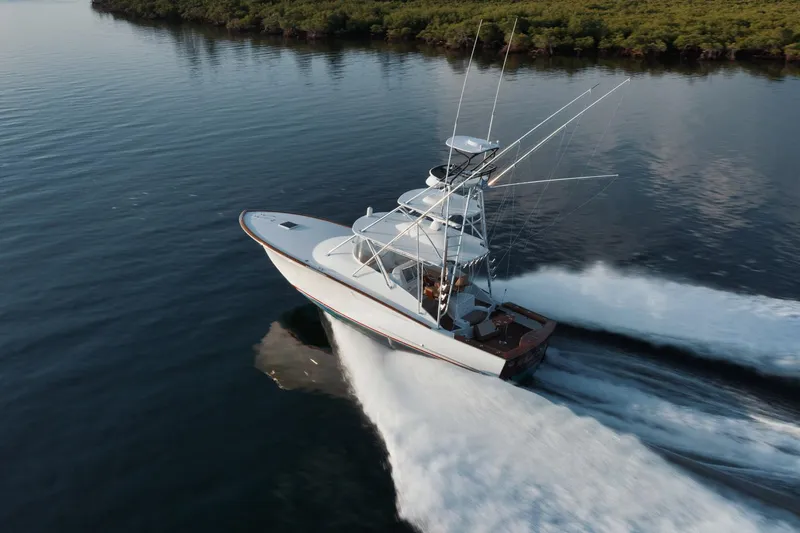 Slide: The Image of 2016 F&S Express boat cruising on calm water near lush shoreline. - 43