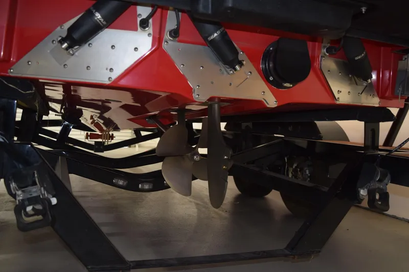 Slide: The Image of 2024 Nautique Ski Nautique boat underside showing propeller and trailer components. - 3