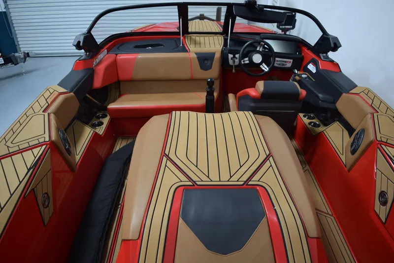 Slide: The Image of 2024 Nautique Ski Nautique interior with red and tan upholstery, sleek design, and modern dashboard. - 5
