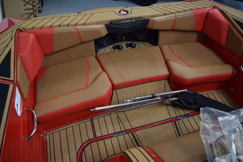 Slide: The Image of 2024 Nautique Ski Nautique interior with tan and red seating, featuring sleek design elements. - 6