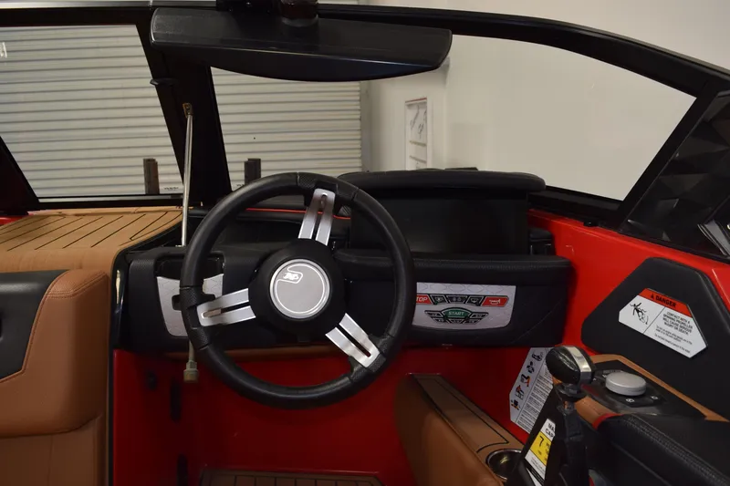 Slide: The Image of 2024 Nautique Ski Nautique boat interior with steering wheel and dashboard controls. - 7