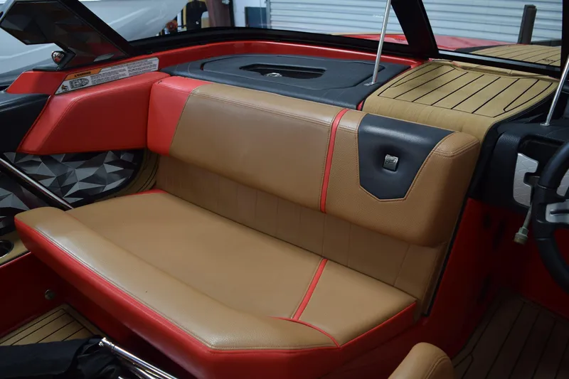 Slide: The Image of 2024 Nautique Ski Nautique interior with tan and red seating, modern design. - 9