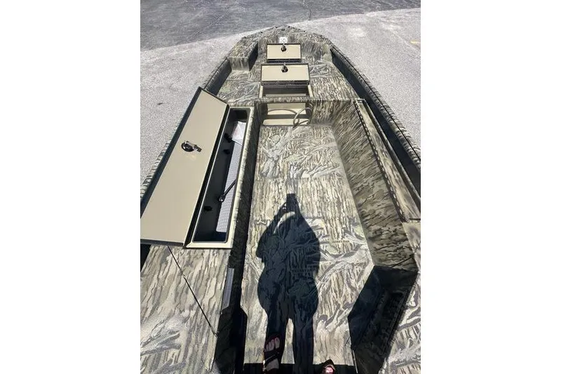 Slide: The Image of 2026 SeaArk 1752 Slayer X boat interior with camouflage design and storage compartments. - 2
