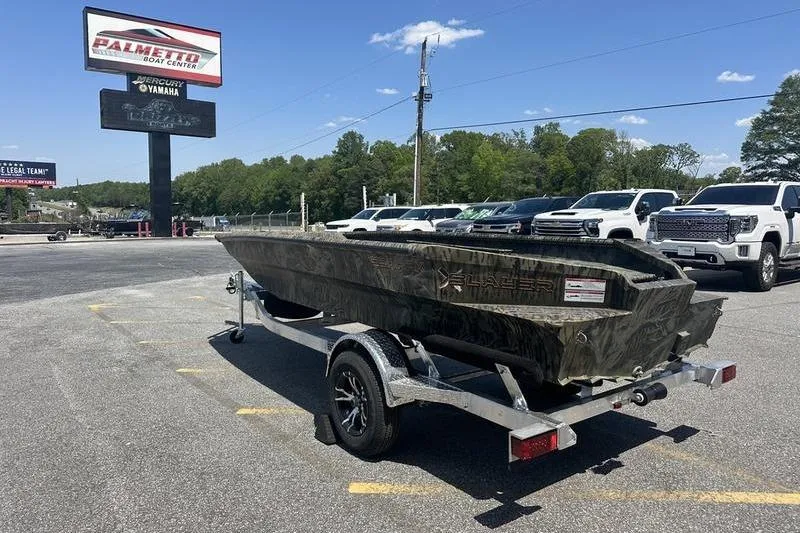 Slide: The Image of 2026 SeaArk 1752 Slayer X boat on trailer at dealership parking lot. - 3