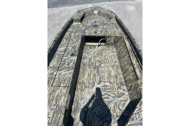 Slide: The Image of 2026 SeaArk 1752 Slayer X boat with camouflage design, viewed from above. - 4