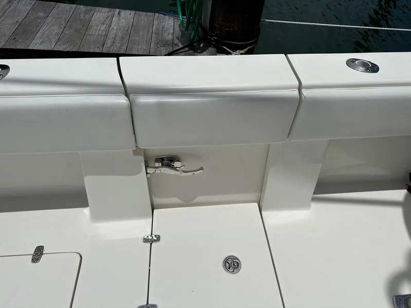 Slide: The Image of 2018 SeaVee 390Z boat deck with white cushioned seating and storage compartments. - 20
