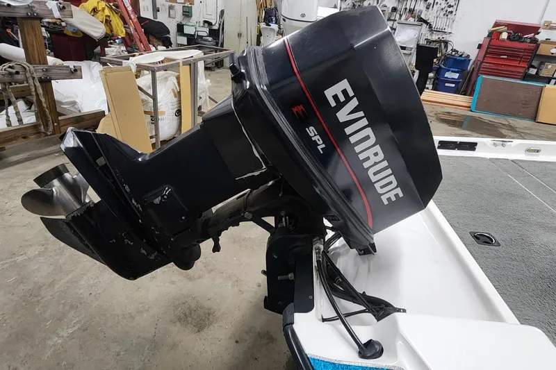 Slide: The Image of 1997 Stratos 268V 17' SC Bass Boat with Evinrude SPL outboard motor in a workshop. - 8