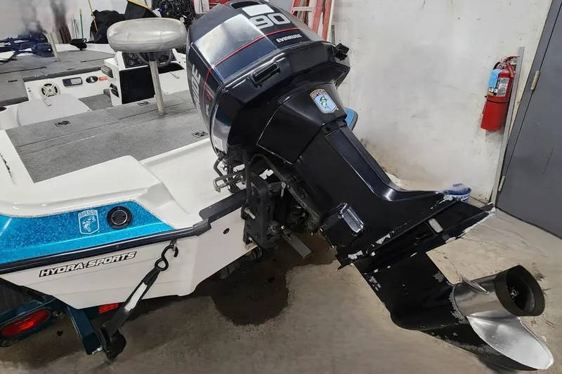 Slide: The Image of 1997 Stratos 268V 17' SC Bass Boat with outboard motor in garage. - 9