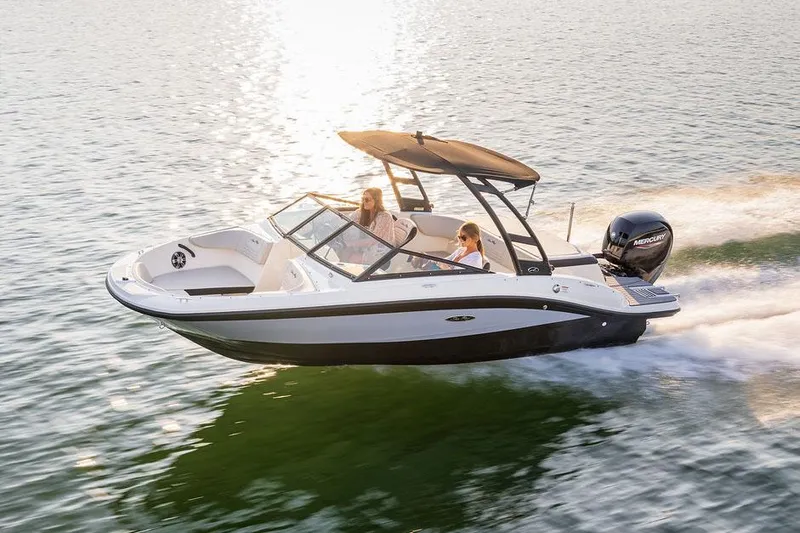 Slide: The Image of Manufacturer Provided Image: 2022 Sea Ray SPX 190 OB boat cruising on water at sunset. - 2