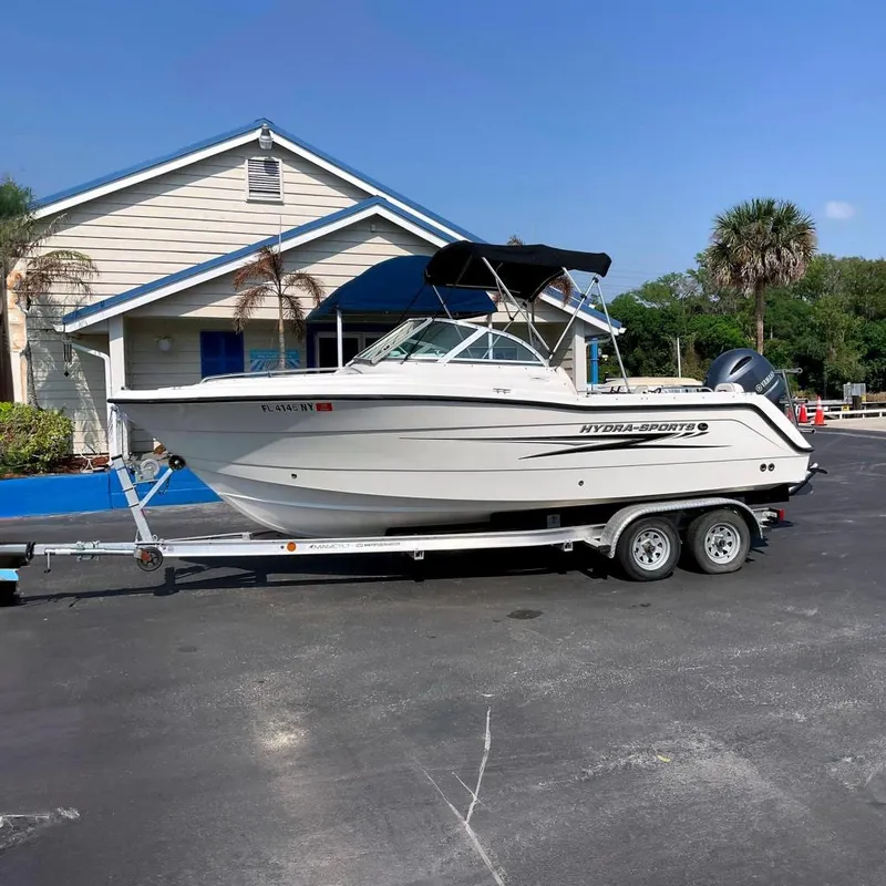 The Image of 2009 Hydra-Sports Lightning 202 DC boat on trailer in front of building. - 0