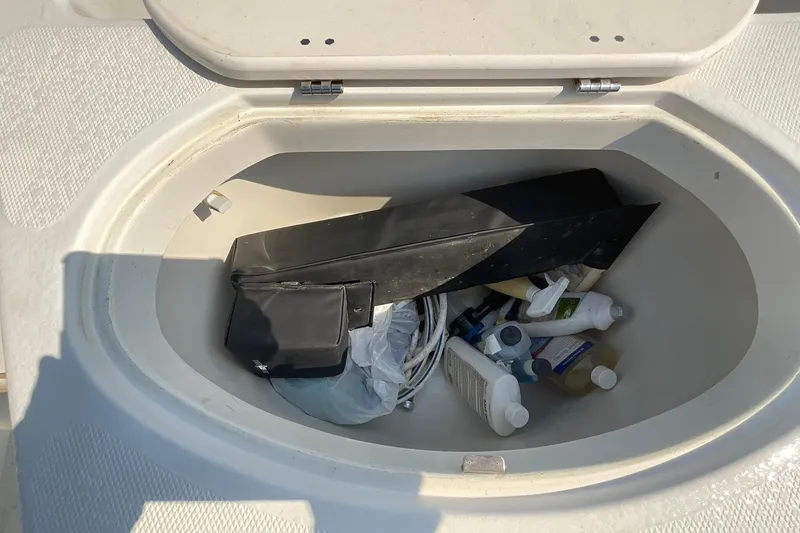 Slide: The Image of Storage compartment of 2009 Hydra-Sports Lightning 202 DC with various items inside. - 10