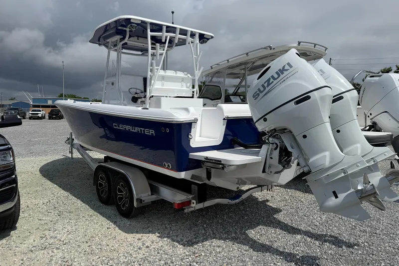 Slide: The Image of 2026 Clearwater 2800 Center Console boat with dual Suzuki engines on a trailer. - 1